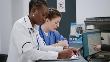 Two nurses looking at documentation