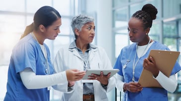 three nurses look over citation data on a tablet