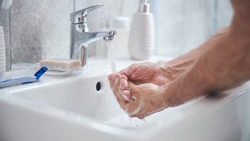 Soapy hands under water representing hand hygiene week