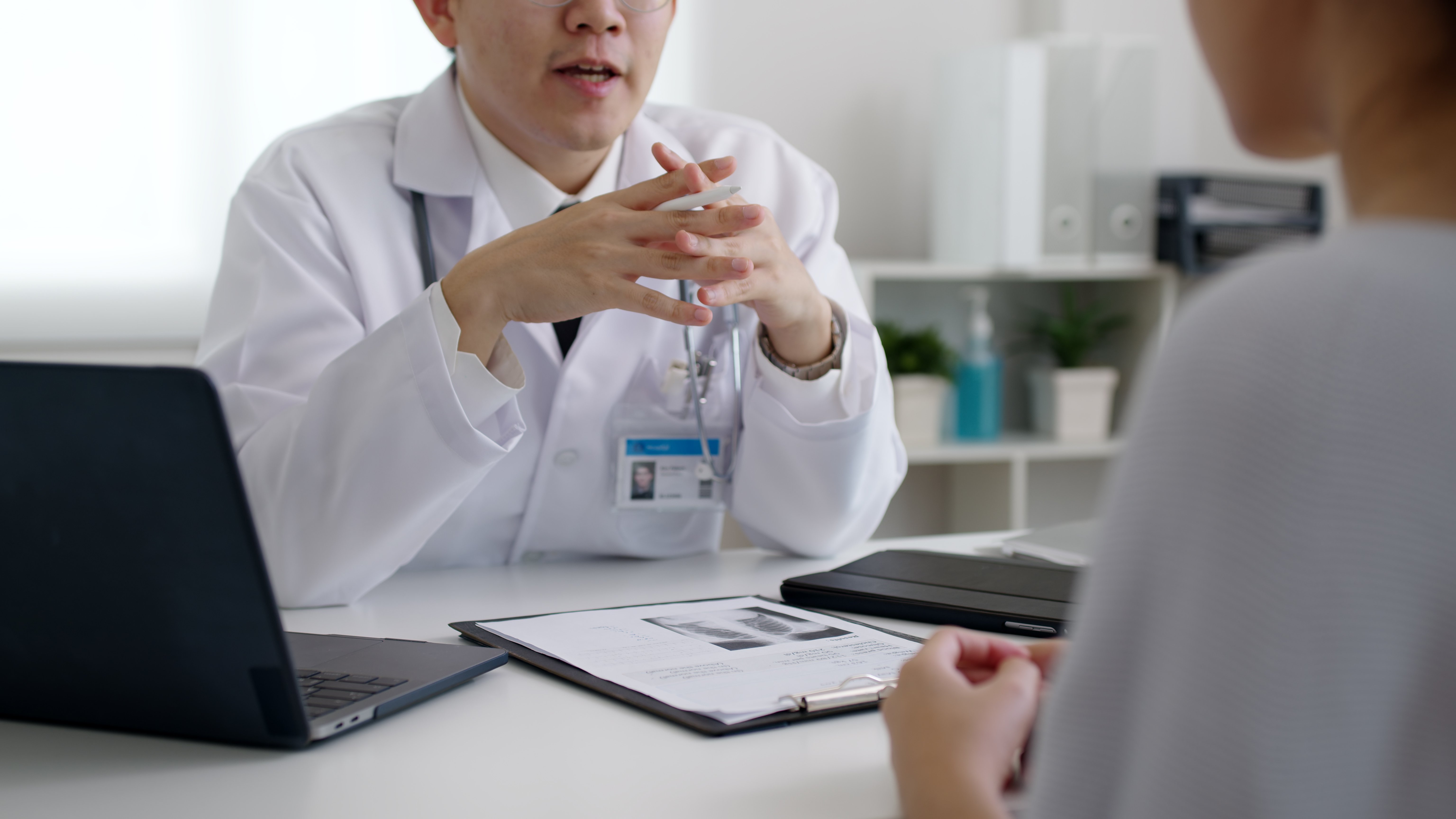 Asian doctor talking to patient