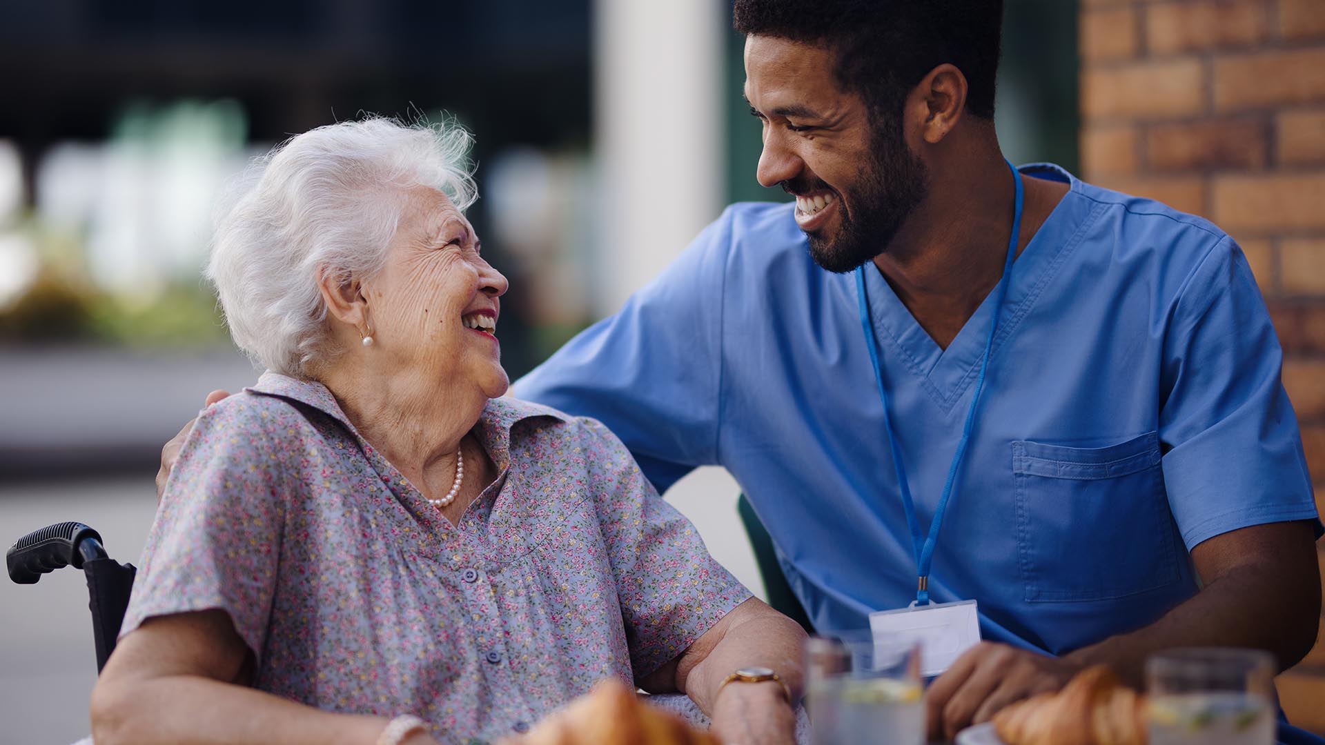 happy nursing home staff member and resident