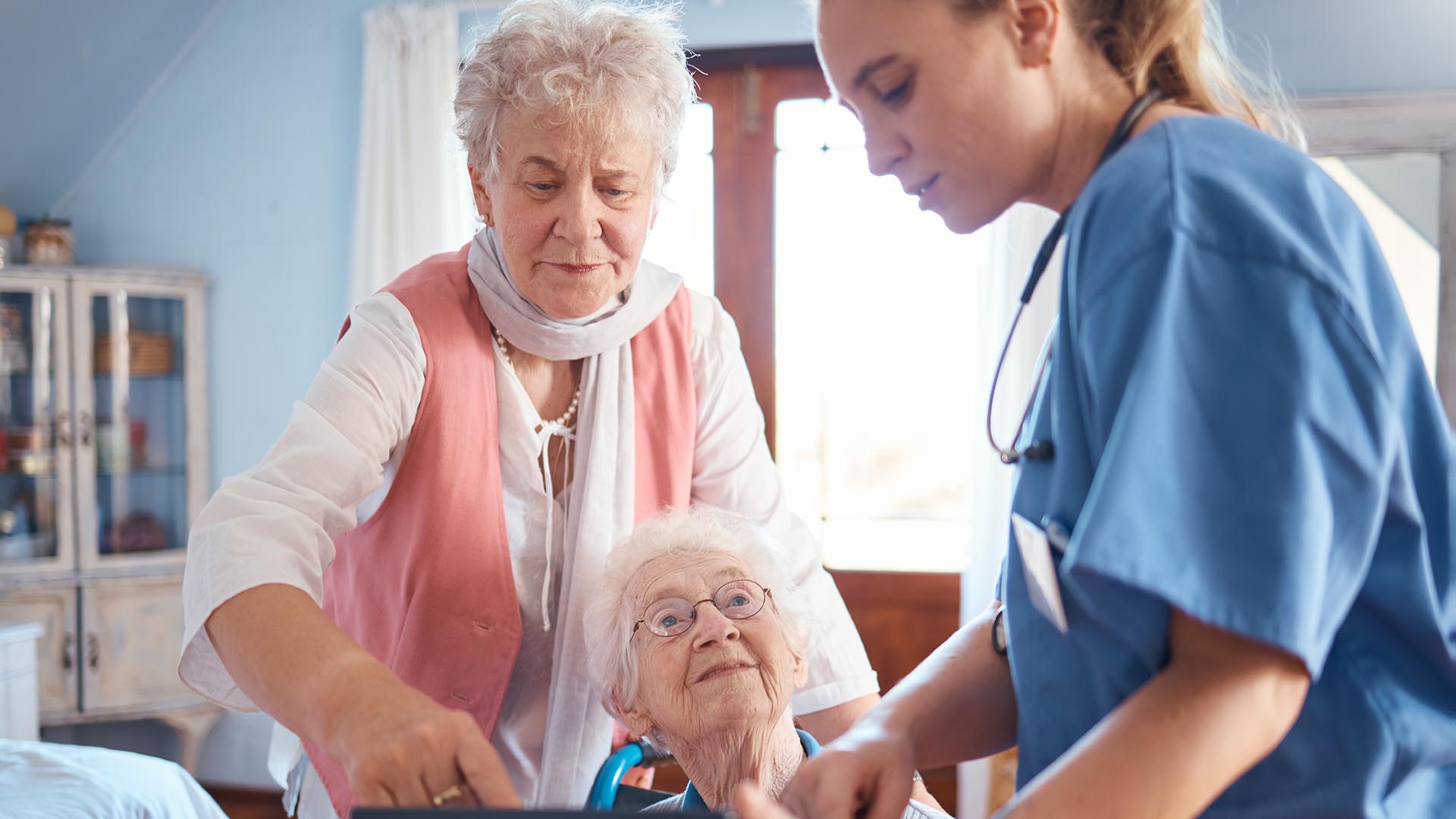 Nurse with two seniors in a nursing home setting