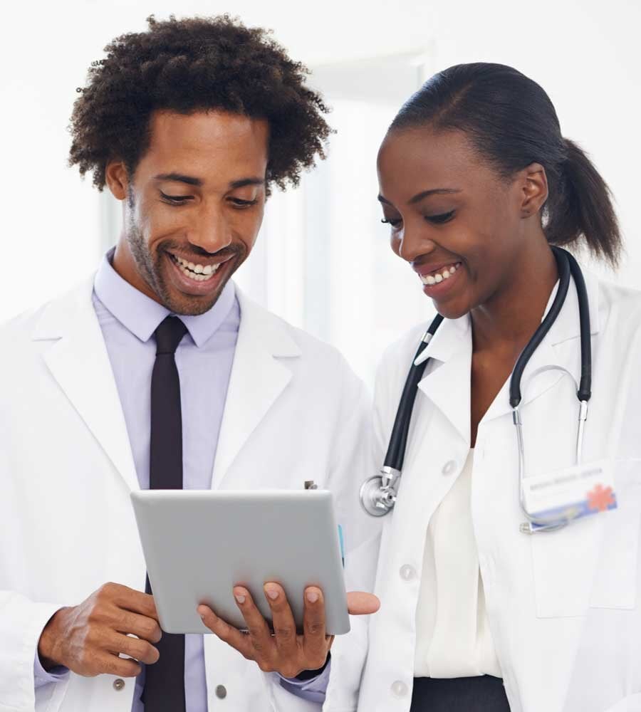 two nurses looking at a tablet