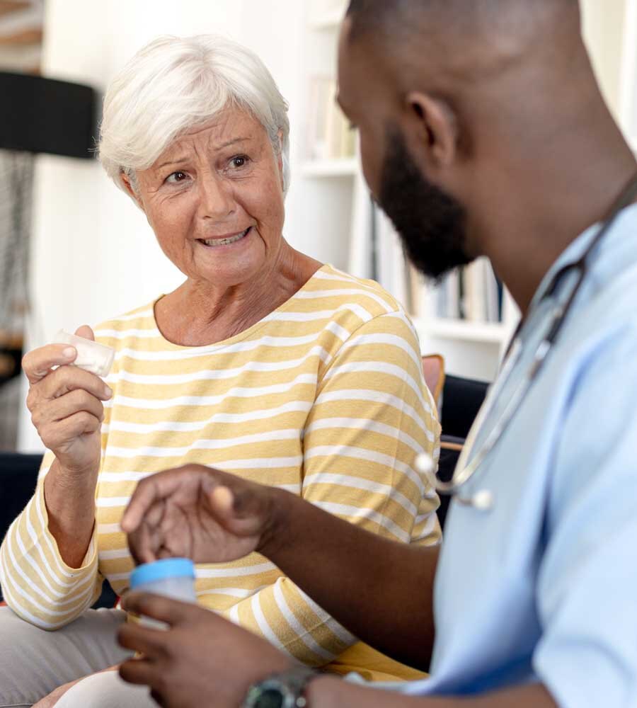 woman with pills talking to nurse